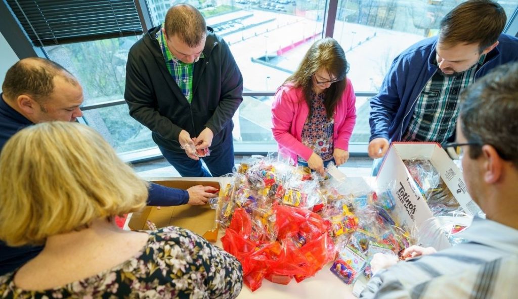 Six IntelliDyne employees packing care packages