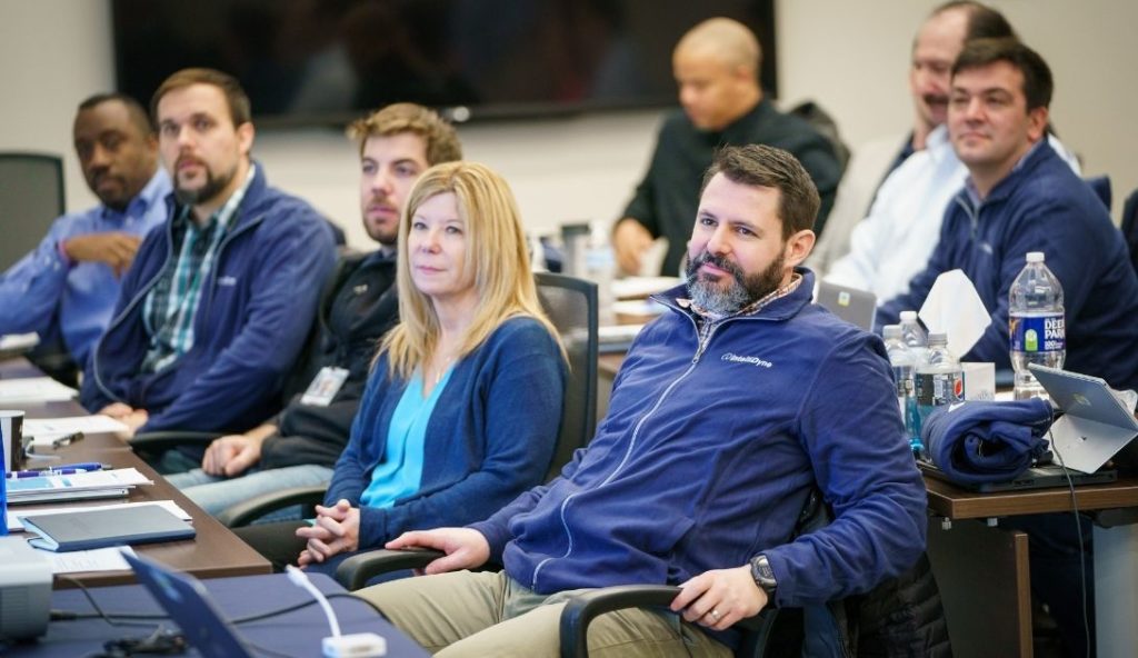 IntelliDyne employees in a training session